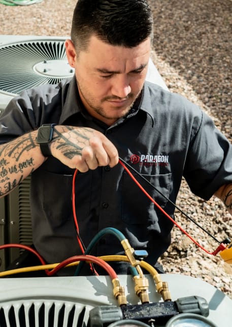 A skilled Paragon Service Pros technician works on an air conditioning unit.
