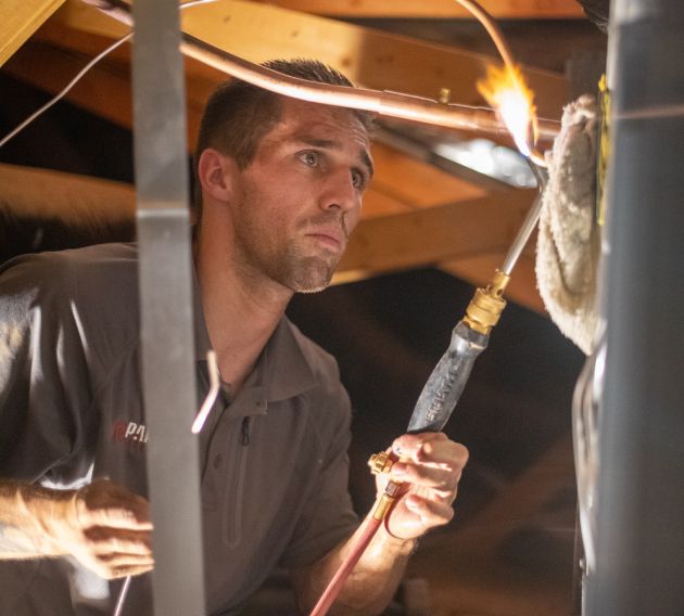 A Paragon Service Pros technician performing heating service.