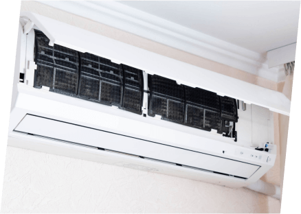 A white air conditioner with a black cover, symbolizing energy efficiency tips for optimal cooling performance.